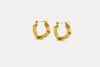 Gold textured hoop earrings with ridged oval profile and clasp back