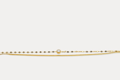Gold double chain bracelet with round gemstone on fine linked band