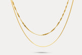 Gold double-layer chain necklace with fine links and curved front