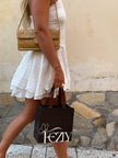 Black shopping tote bag with white FEZY logo and butterfly icon, side view