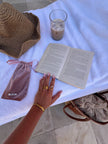 Gold-tone dual band ring with two gem-like stones, worn on a finger